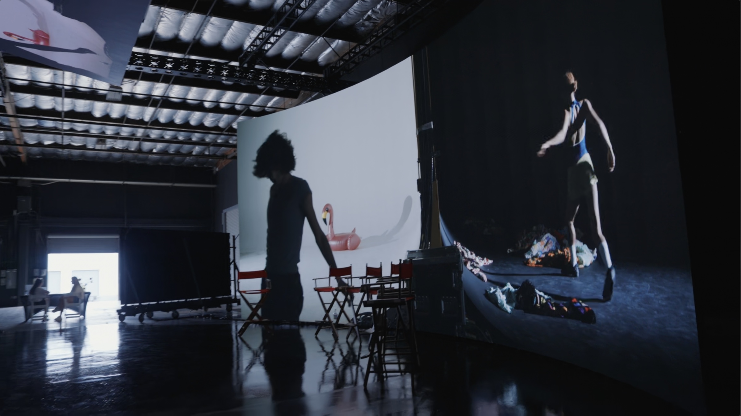 Dance films projected across large screens in a screening space